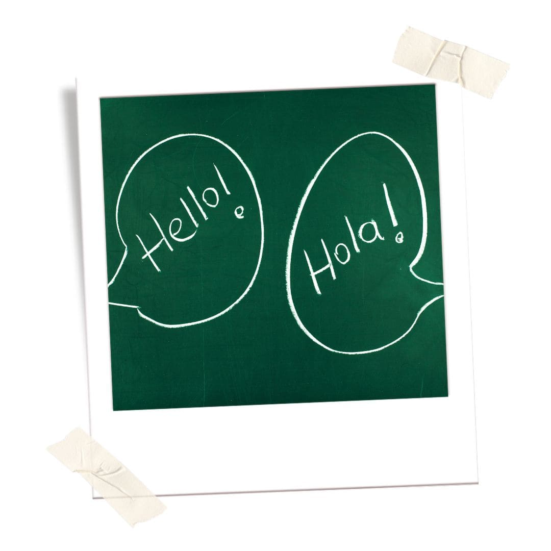 Chalkboard with writing of "hola" and "hello"